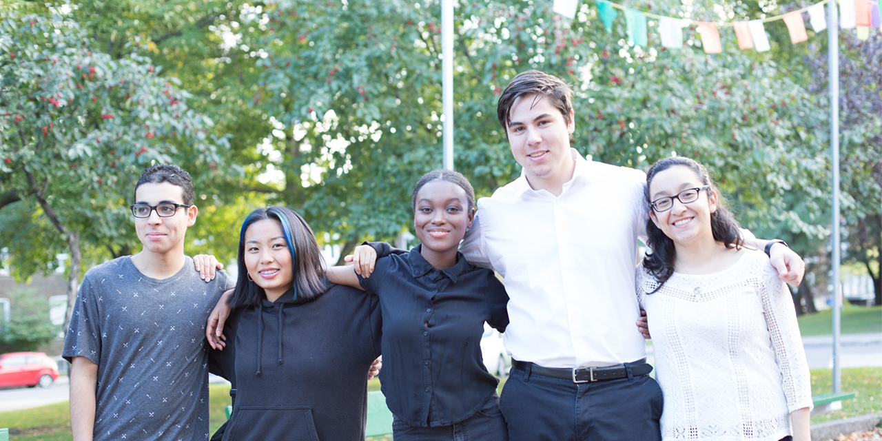 Group of Pathways students standing side by side with arms around each other